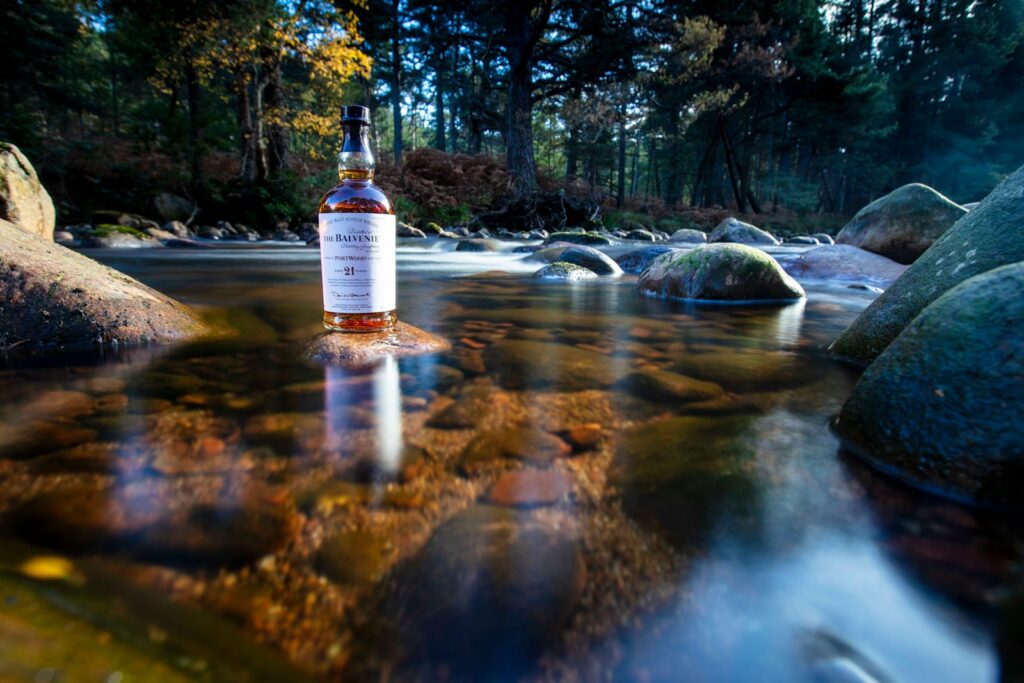 a bottle of alcohol in a stream Whisky with Water